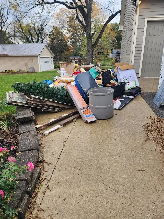 Dumpster being loaded with debris for 10 Yard Dumpster Rental in South Bend